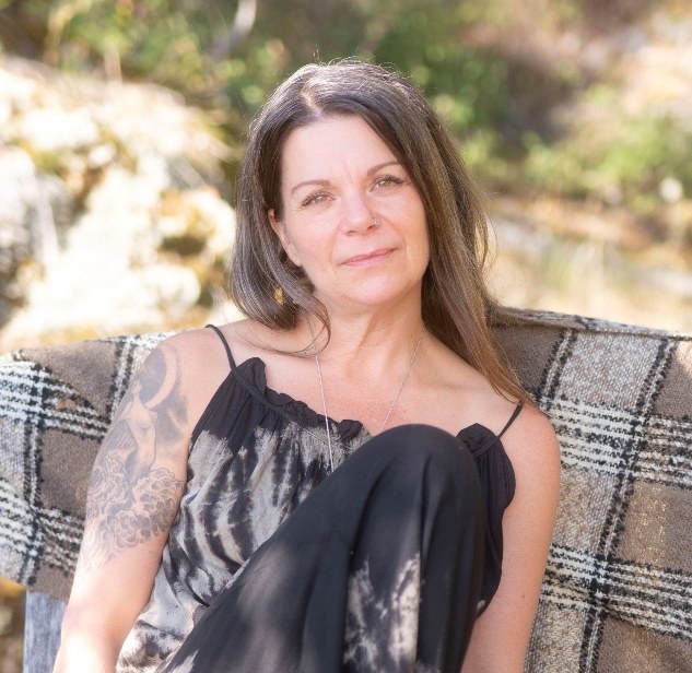 Kimberly Flear seated outdoors