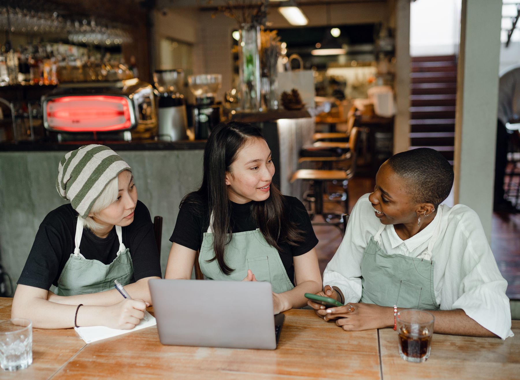 Restaurant staff planning together at a laptop