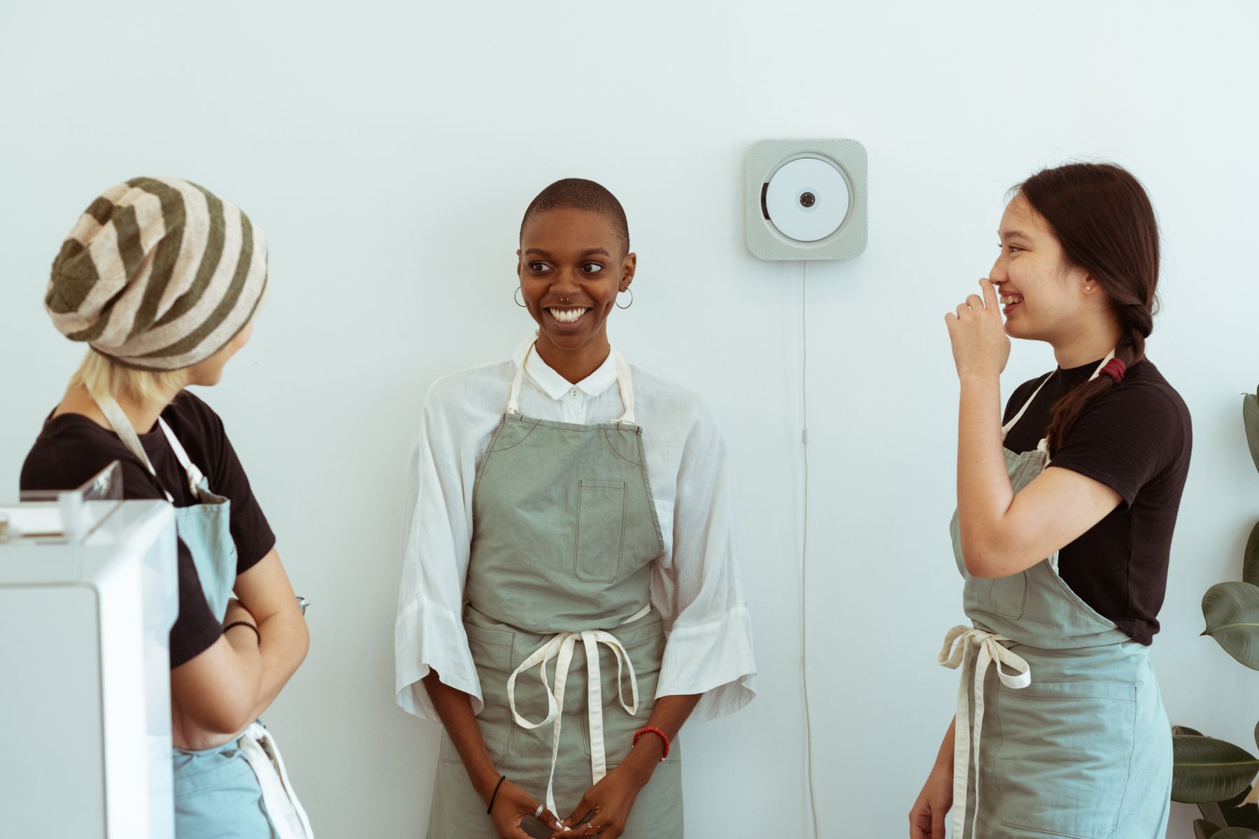 Three restaurant staff laughing together
